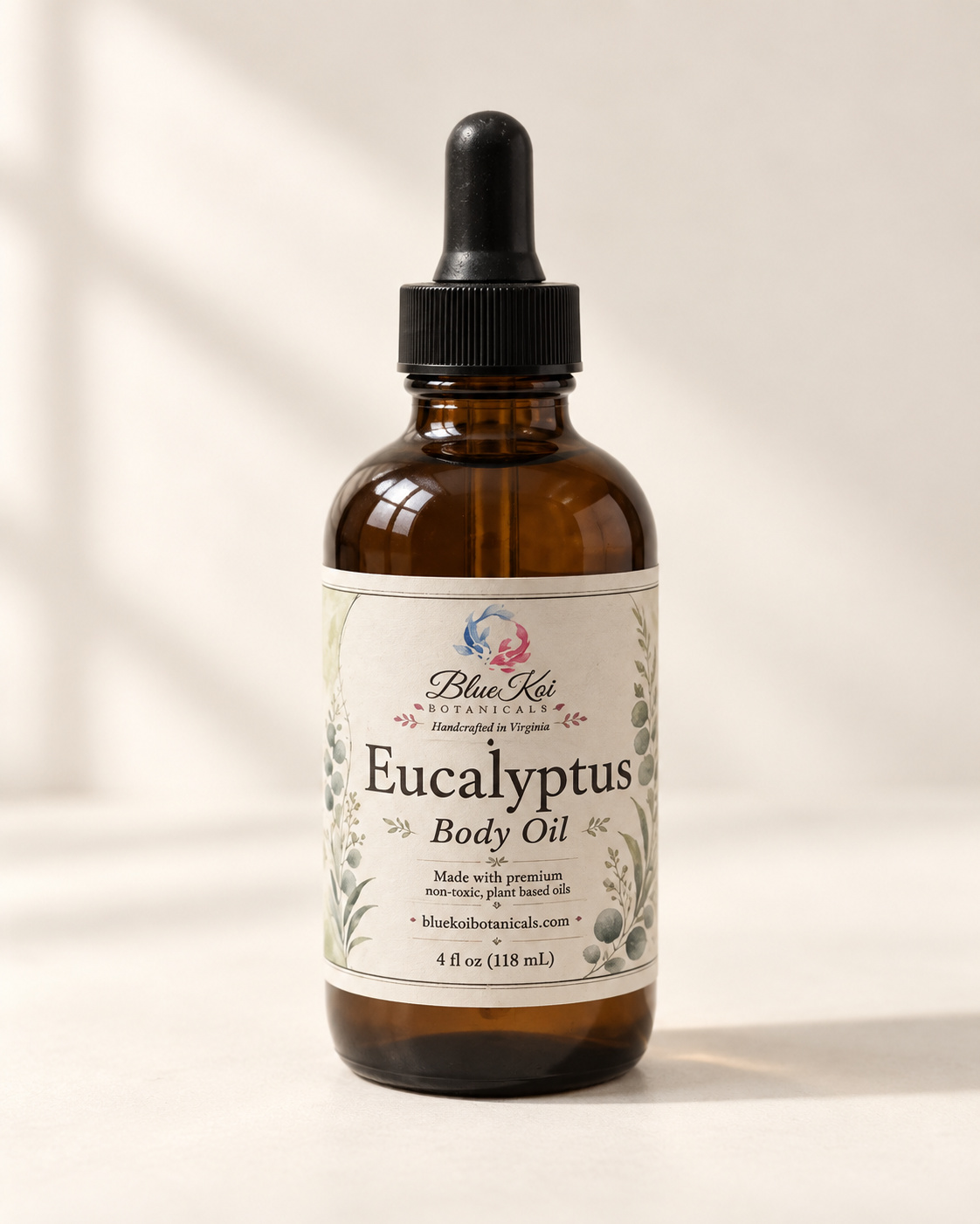 Blue Koi Eucalyptus Body Oil in an amber glass bottle